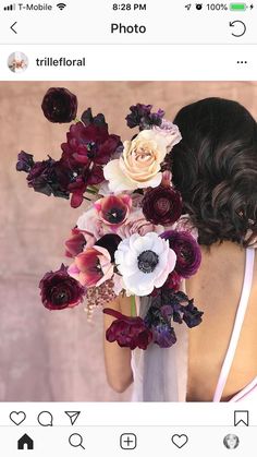 a woman holding a bouquet of flowers in her hands