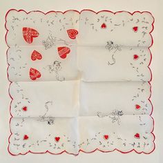 four napkins with red hearts on them are arranged in the shape of a square