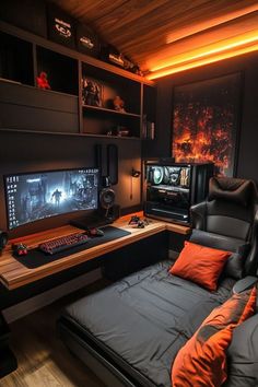 a bedroom with a bed, desk and computer monitor