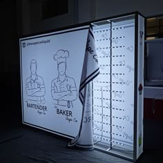 an advertisement for bakers is displayed on the side of a building in the dark