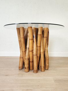 there is a glass table with bamboo sticks on it