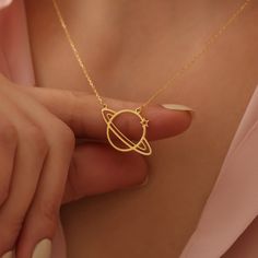 🌌 Discover the wonders of the cosmos with our exquisite Saturn Necklace, a symphony of celestial charm and minimalist elegance. This handcrafted piece serves as a perfect birthday gift or a token of love for the special woman in your life. 🎁 Ideal Gift for Her: Whether you're seeking a thoughtful mothers day gift, a unique gift for mom, or a sentimental gift for lover, this custom necklace is imbued with affection and significance, ensuring a smile on the face of your beloved. 🪐 Unique Space Gold Saturn Necklace, Space-themed Gold Jewelry Gift, Celestial Satellite Chain Jewelry As Gift, Celestial Jewelry With Satellite Chain For Gifts, Celestial Jewelry With Satellite Chain As A Gift, Celestial Style Jewelry With Satellite Chain As Gift, Saturn Necklace, Galaxy Jewelry, Galaxy Necklace