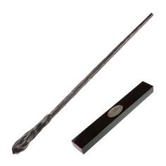 a harry potter's wand and its box on a white background