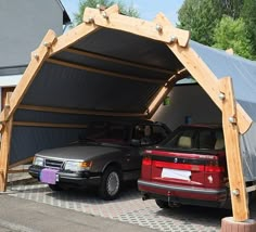 two cars are parked in an attached carport