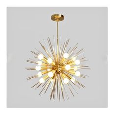 a gold chandelier with white balls hanging from it's center and the light bulb turned on