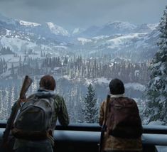 two people looking out over a snowy mountain