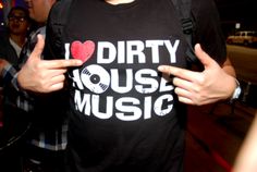 a man wearing a dirty house music t - shirt with his hands in the air