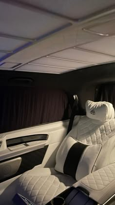 the interior of a luxury car with black and white accents