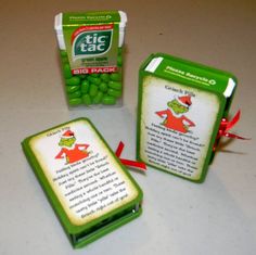 some green candies are sitting on a table next to a package of mints