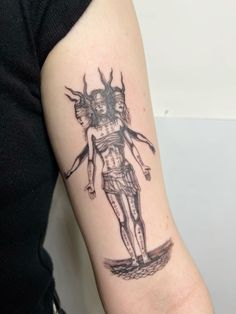 a person with a tattoo on their arm that has a drawing of a woman holding an umbrella