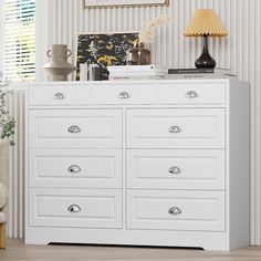 a white dresser with drawers in a room