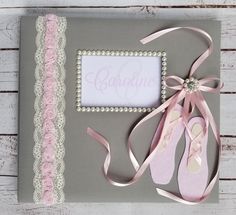 a baby's first birthday card with pink ballet shoes and lace on the edge