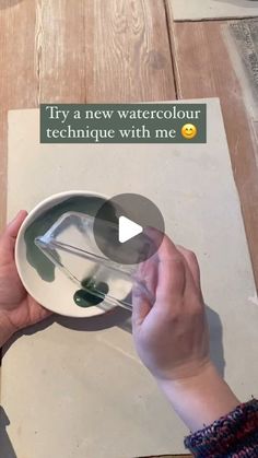 a person is holding a plate with some food on it and the words try a new watercolour technique with me