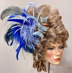 + + + Historical Wig - Marie Antoinette - Blue + + + haircolor: powdered ash blonde feather-color: variation - blue Size: suitable for a head circumference of < 57 cm  The well-coiffured wig (synthetic hair) is adorned with feathers of roosters and ostriches and rhinestones. It will be delivered on a polystyrene head. I create these extraordinary pieces of jewelry in the atelier for "Maskenzauber & Erlebenskunst" in Berlin. Anyone who wants to visit me there is very welcome. Please make an appoi Marie Antoinette Wig, Blue Feathers, Blue Feather, Colorful Feathers, Ash Blonde, Marie Antoinette, Head Circumference, Rococo, Synthetic Hair