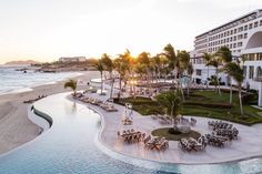 an aerial view of the beach and resort at sunset, with tables and chairs set up on the sand