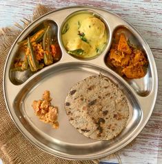 a silver plate topped with different types of food