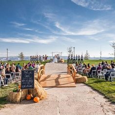 an outdoor ceremony with hay bales and pumpkins