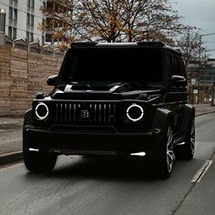 a black jeep is driving down the street