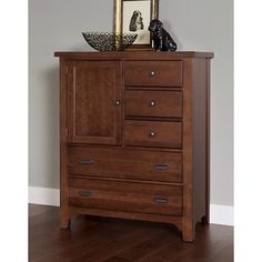 a wooden dresser with drawers and a mirror on it's top shelf next to a dog figurine