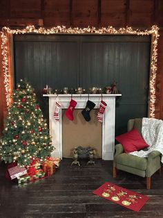 a living room decorated for christmas with stockings on the fireplace