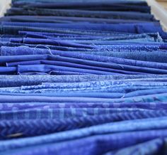 several rows of blue cloths are lined up