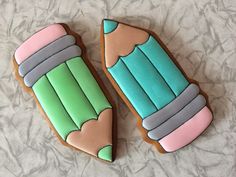 two decorated cookies sitting on top of a table