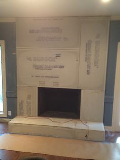 an unfinished fireplace being installed in a living room