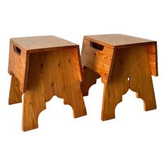 two wooden stools sitting next to each other