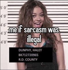 a woman with long hair standing in front of a jail cell phone and smiling at the camera