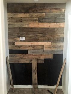 a bathroom with wood planks on the wall