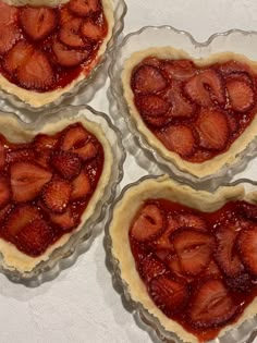 four heart shaped pies with strawberries in them