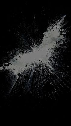 the dark knight rises movie poster with batman's face in the middle of it