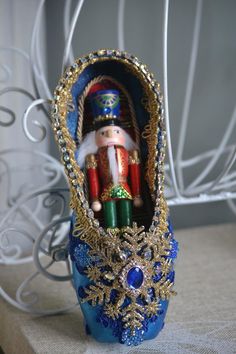 a nutcracker is sitting in a blue box