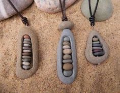 three necklaces made out of rocks and stones on the sand with beads in them