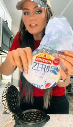 a woman holding a bag of frozen yogurt