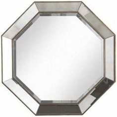 a mirror that is sitting on top of a table with a black base and silver trim