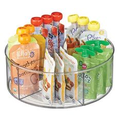 a clear plastic container filled with lots of juices and drinks on top of a metal shelf