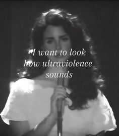 a woman holding a microphone with the words i want to look how ultravoilence sounds