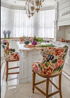 a kitchen with two chairs and a chandelier hanging from the ceiling