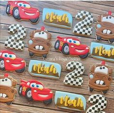 decorated cookies with cars and checkered paper on wooden table top, ready to be eaten