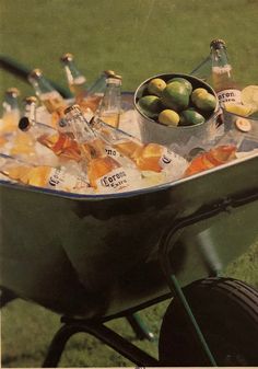 a wheelbarrow filled with assorted drinks and snacks