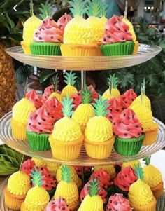 three tiered trays with cupcakes and pineapples on them for bridal shower 101