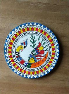 a colorful plate sitting on top of a wooden table