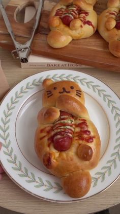 the bread is shaped like a cat with hot dogs on it