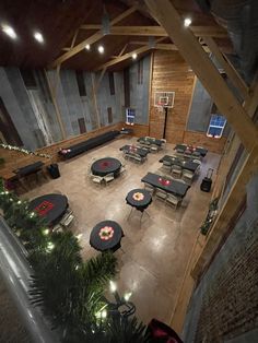 an indoor basketball court with tables, benches and lights on the ceiling is lit up at night