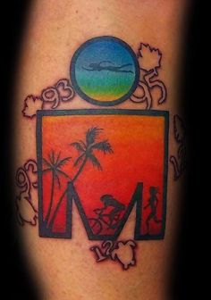 a colorful tattoo on the leg of a man with a palm tree and beach scene