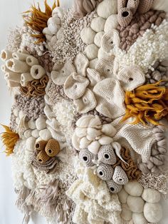 an art work made out of knitted wool and yarn balls, with various animals on them