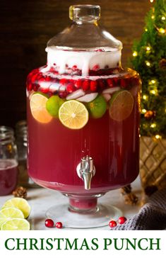 a drink dispenser with cranberry punch and limes