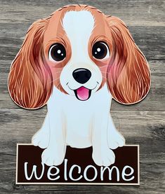 a brown and white dog sitting on top of a wooden floor next to a welcome sign