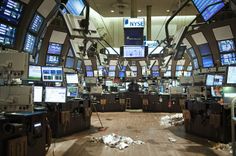 a large room filled with lots of monitors and tvs on top of wooden floors